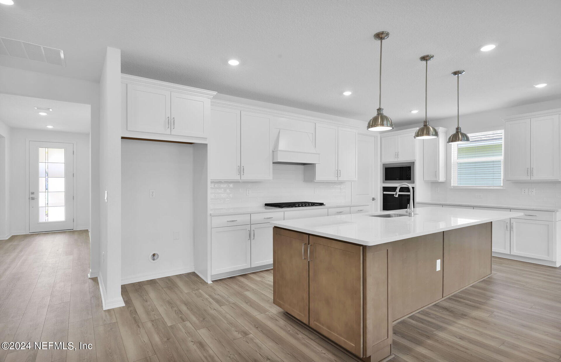 236 Hickory Pine Drive St. Augustine, FL 32092 - Photo 9 of 46 a kitchen with stainless steel appliances kitchen island a cabinets and wooden floor