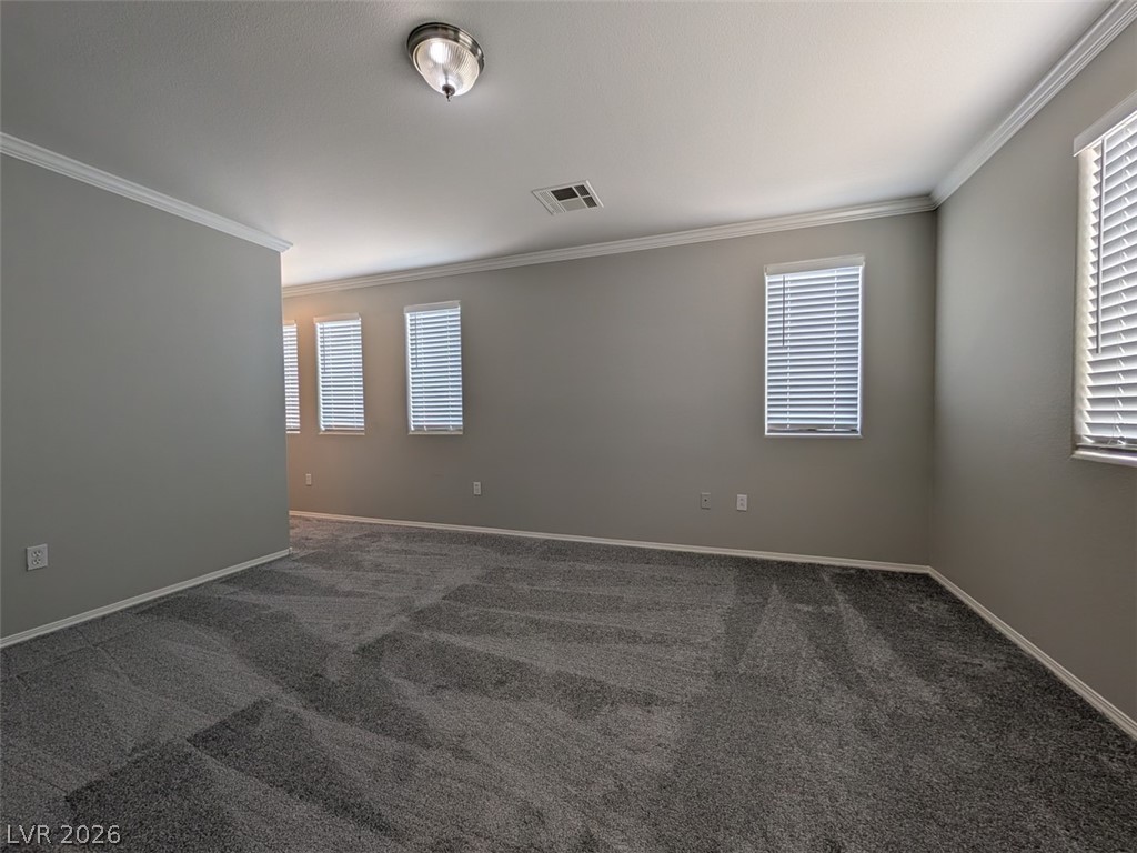 10308 Faustine Avenue Las Vegas, NV 89129 - Photo 8 of 28 Well-lit and versatile, this spacious room features elegant crown molding and soft carpeting.