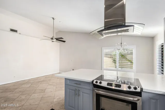 a kitchen with a stove and a window