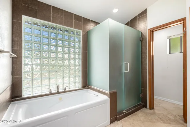 a bathroom with a bathtub and a shower