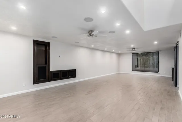 an empty room with a empty space and a ceiling fan
