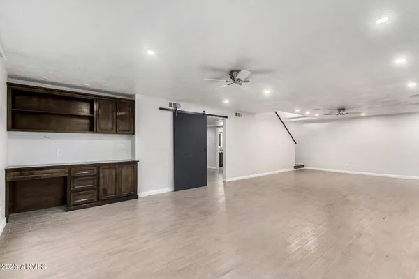 a view of an empty room with a kitchen