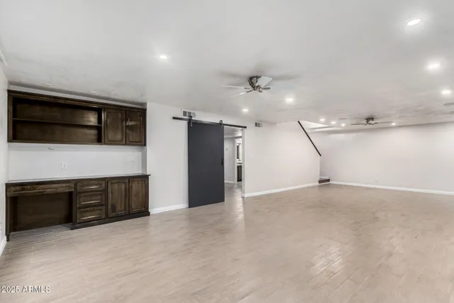 a view of an empty room with a kitchen