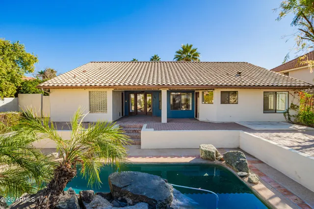 a front view of a house with a garden and patio