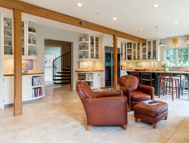 a living room with furniture and a book shelf