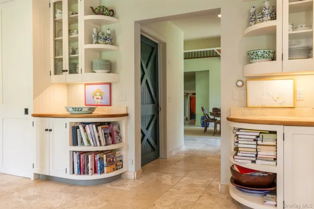 a living room with furniture and a book shelf