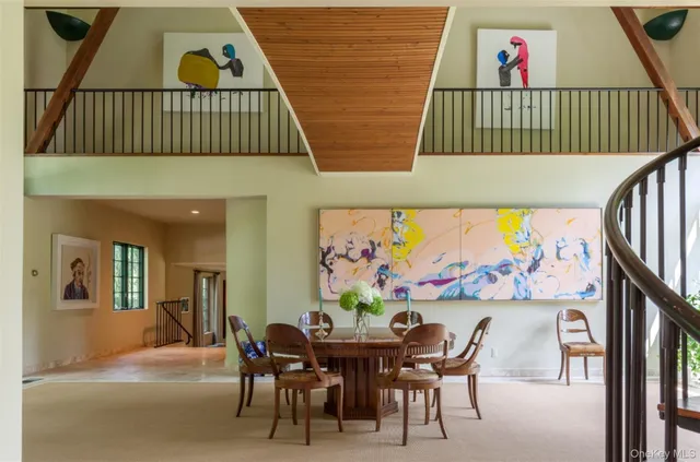 a view of a dining room with furniture and a rug