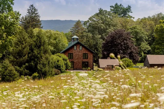 a yellow house with trees in front of it