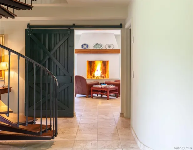 a view of living room with furniture and a fireplace