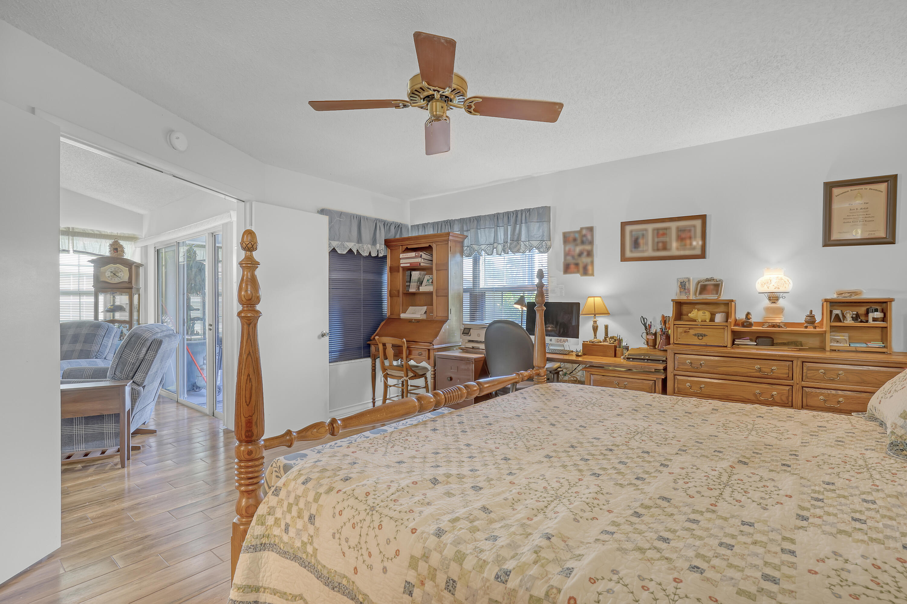 13116 Quiet Woods Road, Unit A Wellington, FL 33414 - Photo 17 of 31 a bed room with a bed and a chair