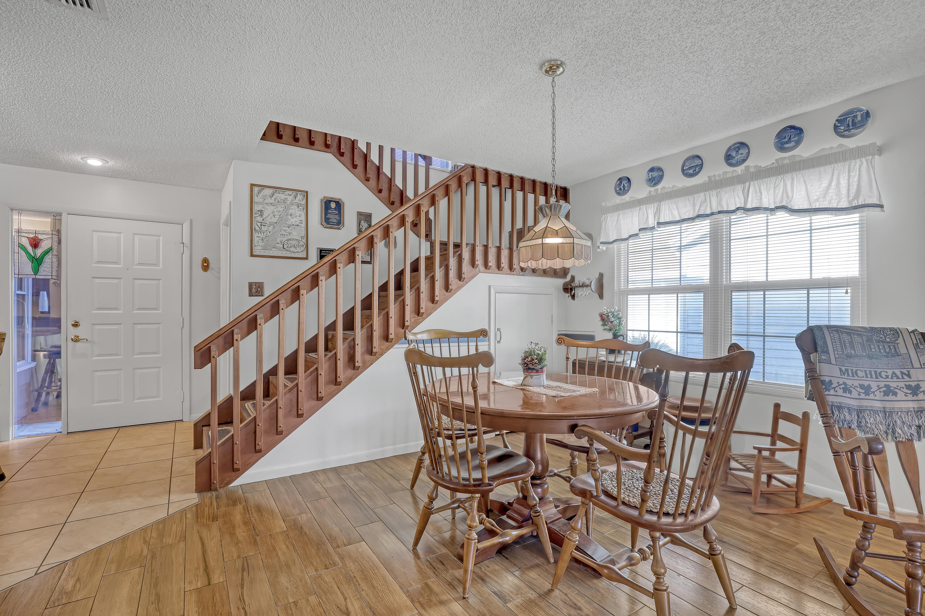 13116 Quiet Woods Road, Unit A Wellington, FL 33414 - Photo 6 of 31 a view of a dining room with furniture and a window