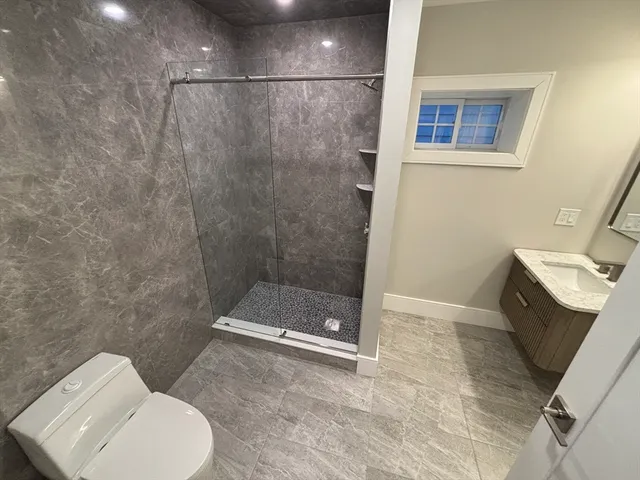 a bathroom with a toilet and a shower