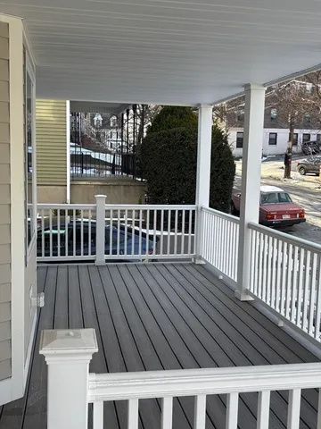 a view of a balcony with wooden floor