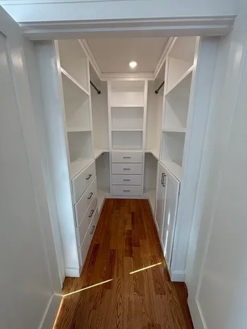 a view of walk in closet with empty racks