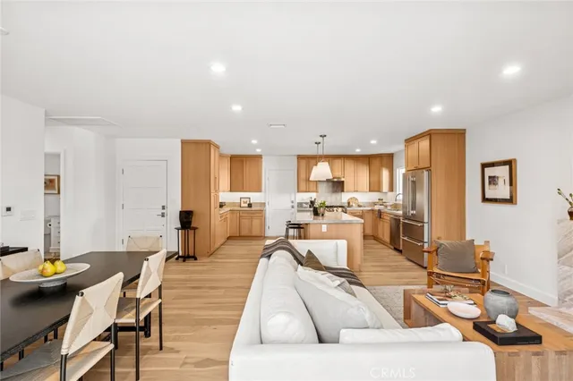 a living room with furniture a chandelier and a flat screen tv