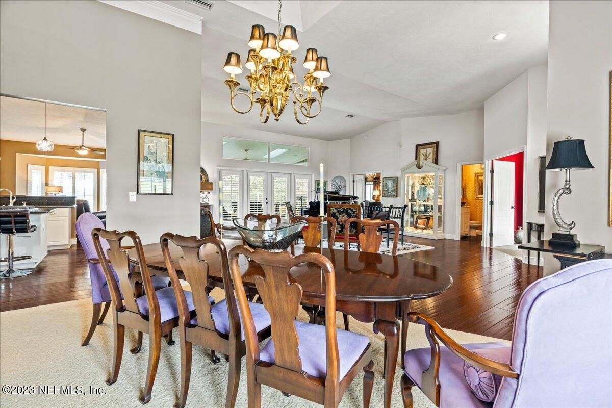 1289 North Cherry Pop Drive Hernando, FL 34442 - Photo 18 of 99 a view of a dining room and livingroom with furniture wooden floor a rug a painting and a chandelier