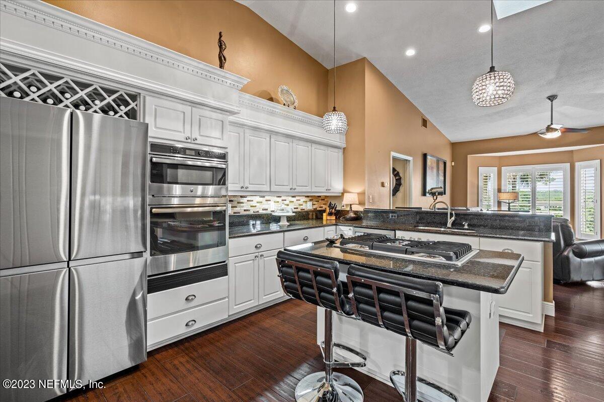 1289 North Cherry Pop Drive Hernando, FL 34442 - Photo 19 of 99 a kitchen with stainless steel appliances a stove a sink and a refrigerator