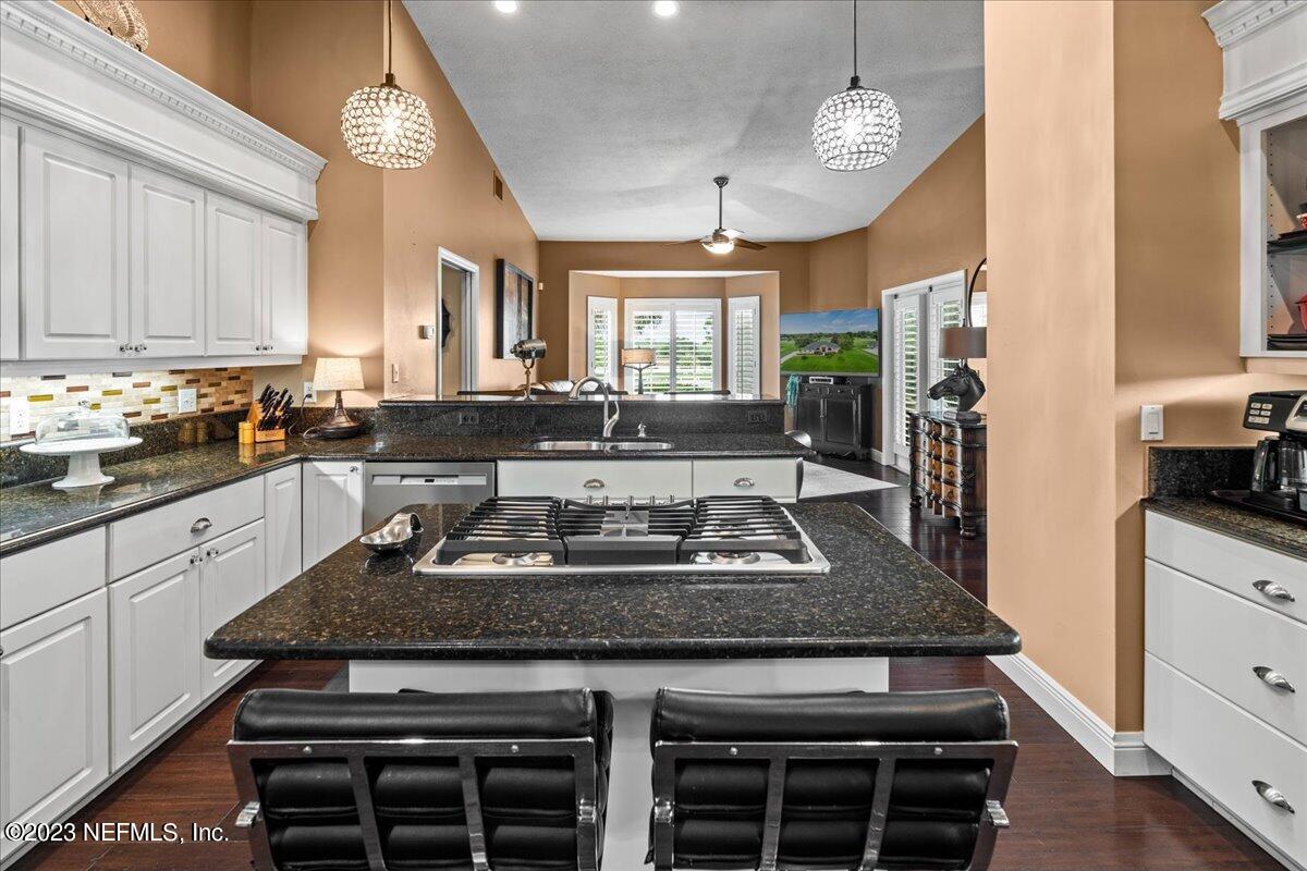 1289 North Cherry Pop Drive Hernando, FL 34442 - Photo 21 of 99 a kitchen with granite countertop a stove a sink and a refrigerator
