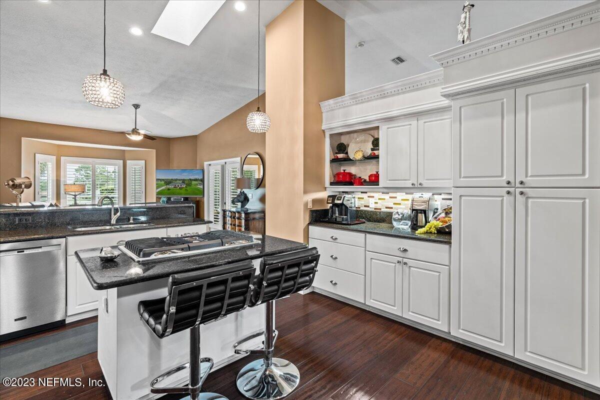 1289 North Cherry Pop Drive Hernando, FL 34442 - Photo 24 of 99 a kitchen with stainless steel appliances a stove a sink dishwasher and white cabinets with wooden floor