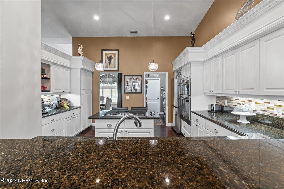 1289 North Cherry Pop Drive Hernando, FL 34442 - Photo 27 of 99 a room with stainless steel appliances kitchen island granite countertop a sink and cabinets