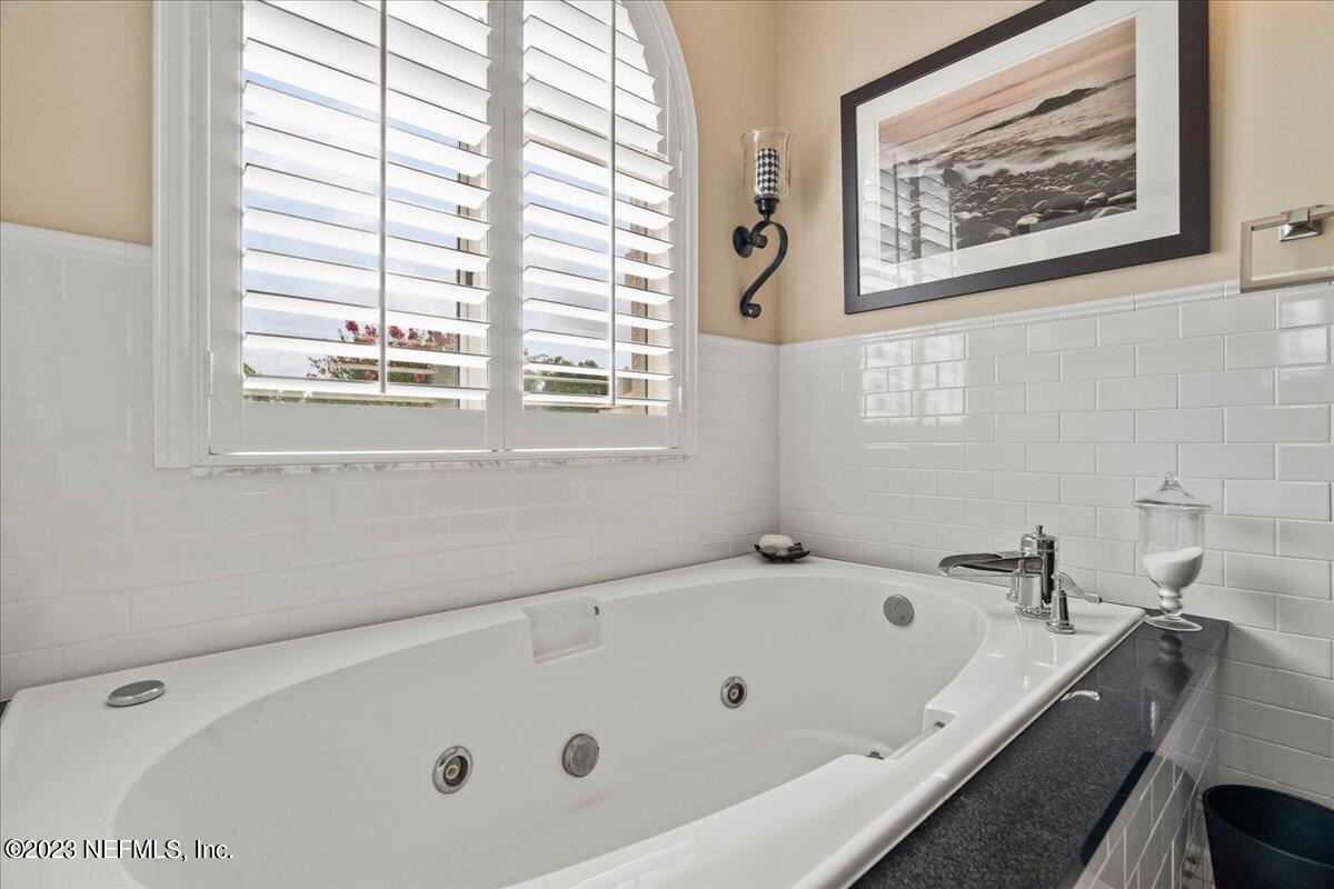 1289 North Cherry Pop Drive Hernando, FL 34442 - Photo 45 of 99 a bathroom with a tub a sink and a window