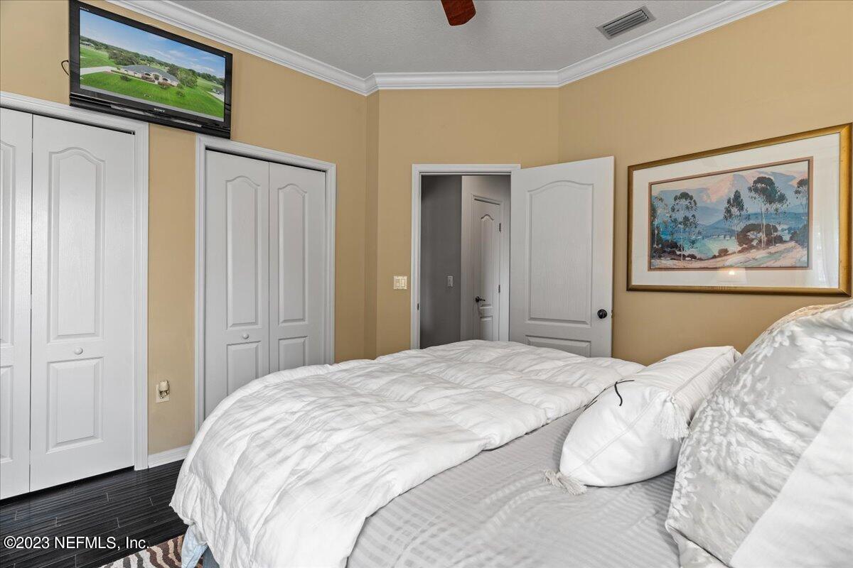 1289 North Cherry Pop Drive Hernando, FL 34442 - Photo 49 of 99 a bedroom with a bed and a painting on the wall