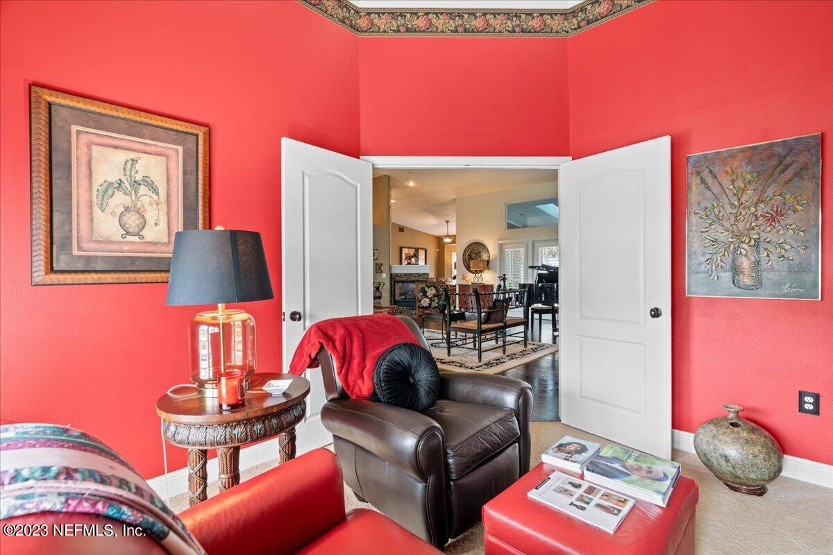 1289 North Cherry Pop Drive Hernando, FL 34442 - Photo 56 of 99 a living room with furniture a lamp and a potted plant