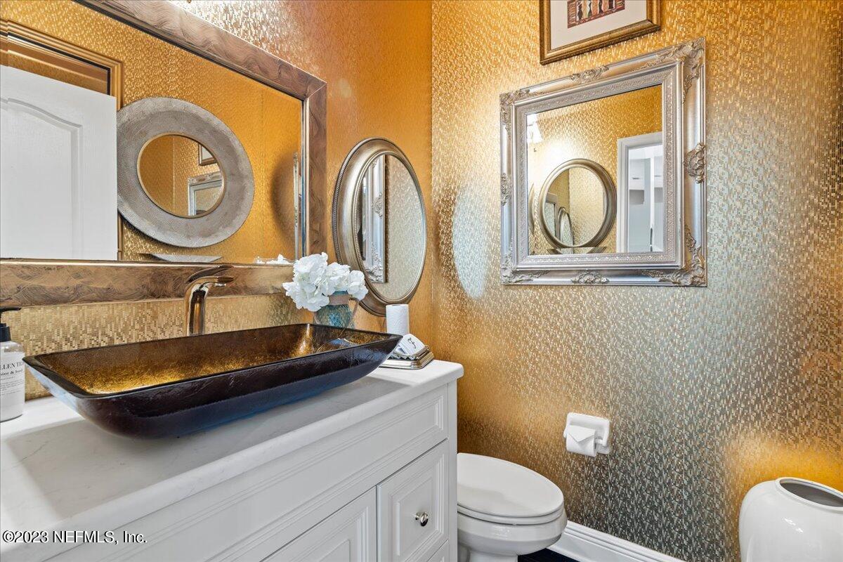 1289 North Cherry Pop Drive Hernando, FL 34442 - Photo 57 of 99 a bathroom with a granite countertop toilet a mirror and a sink