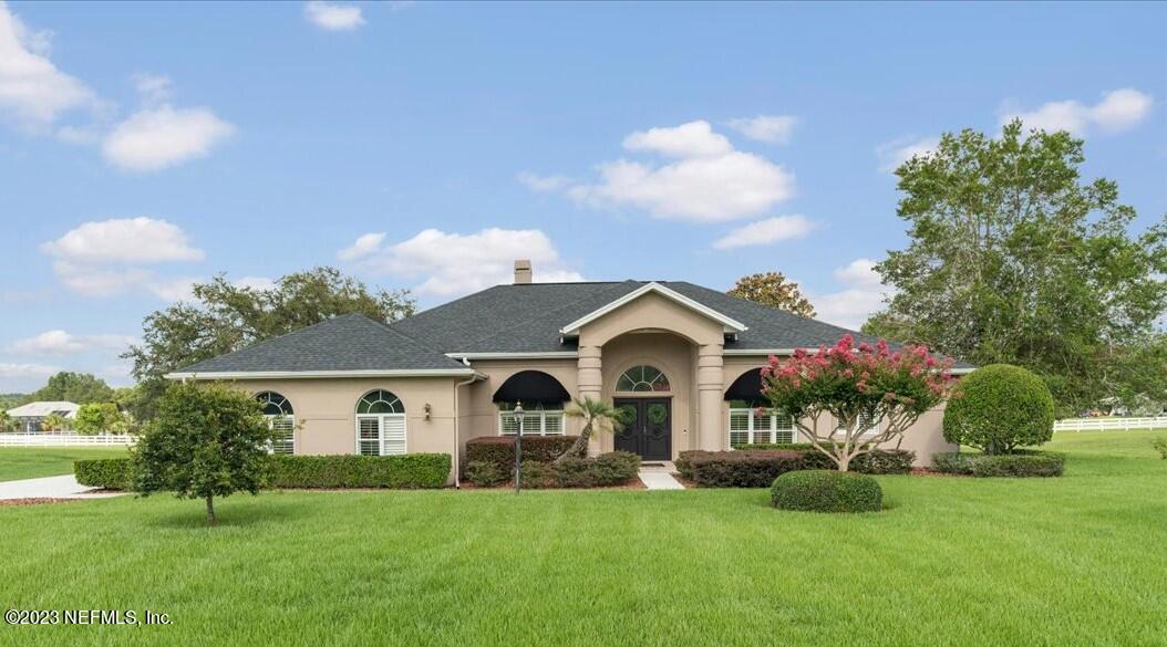 1289 North Cherry Pop Drive Hernando, FL 34442 - Photo 6 of 99 a front view of a house with a garden and plants
