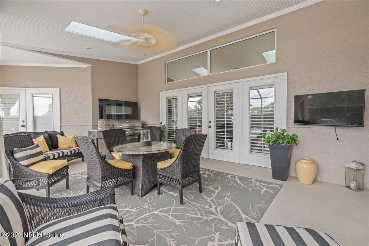 1289 North Cherry Pop Drive Hernando, FL 34442 - Photo 62 of 99 a living room with furniture a flat screen tv and large window