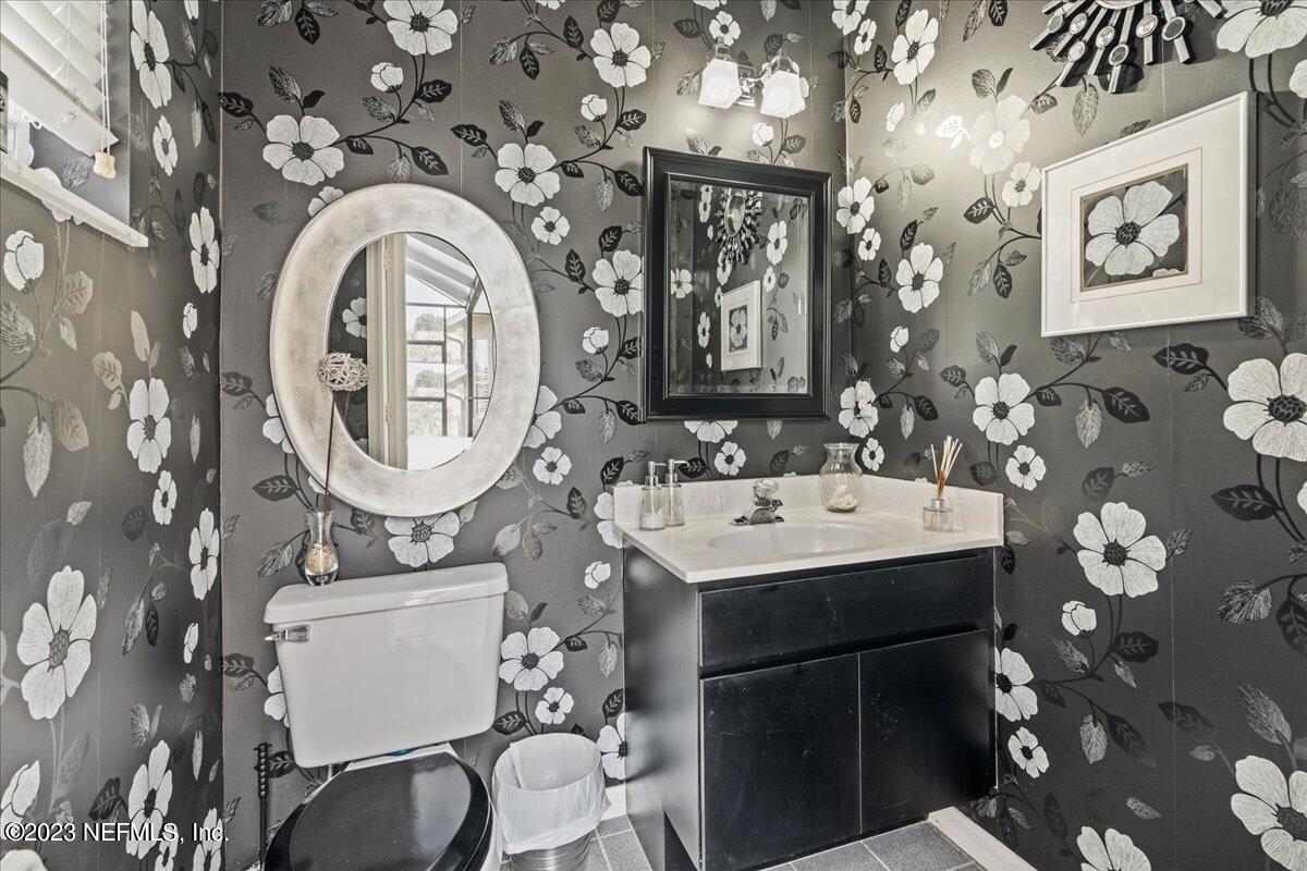 1289 North Cherry Pop Drive Hernando, FL 34442 - Photo 70 of 99 a bathroom with a toilet a sink and a mirror