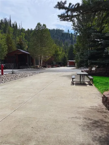 a view of a terrace with a garden and trees