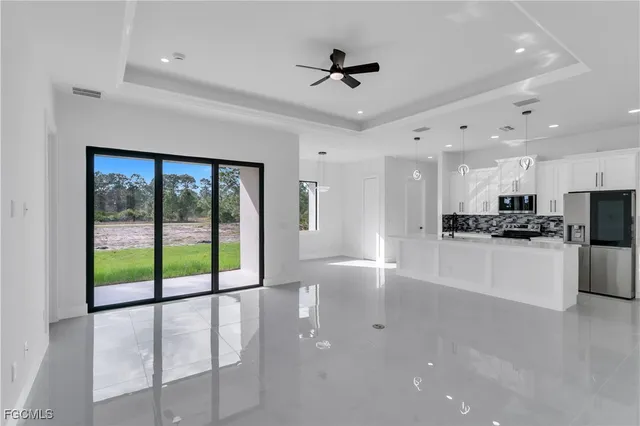 a view of a kitchen with a sink and stainless steel appliances