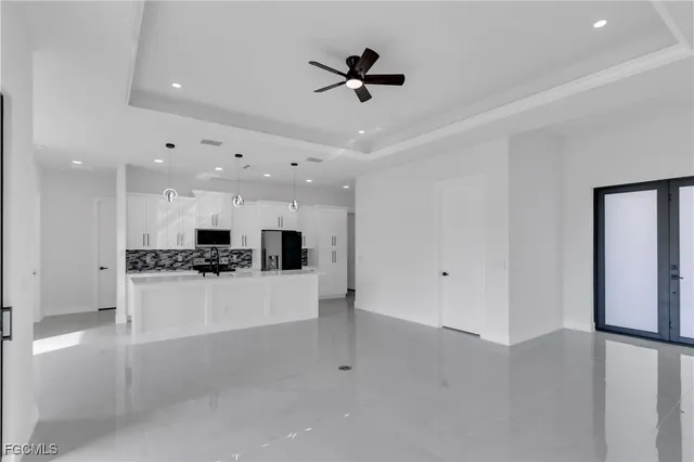 a view of a kitchen with refrigerator and a stove