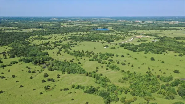 a view of a green field with an outdoor space
