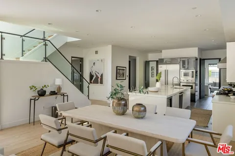 a kitchen with stainless steel appliances kitchen island granite countertop a sink and cabinets