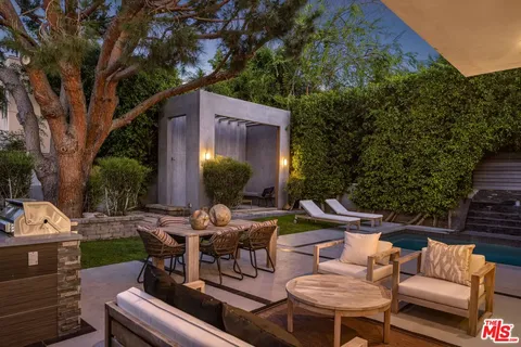 a view of a house with backyard porch and sitting area