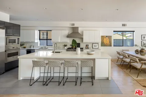 a large kitchen with a table and chairs in it