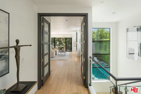 a bedroom with furniture a large window and a fireplace