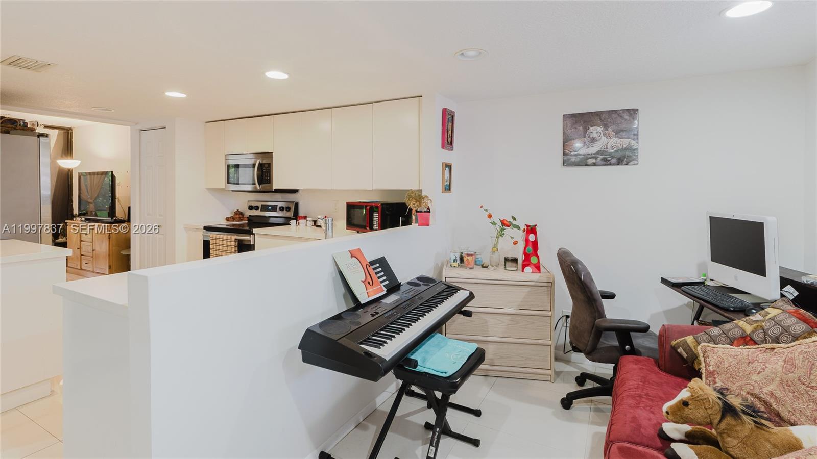 101 Southwest 96th Terrace, Unit 101 Plantation, FL 33324 - Photo 11 of 37 a living room with furniture and a flat screen tv