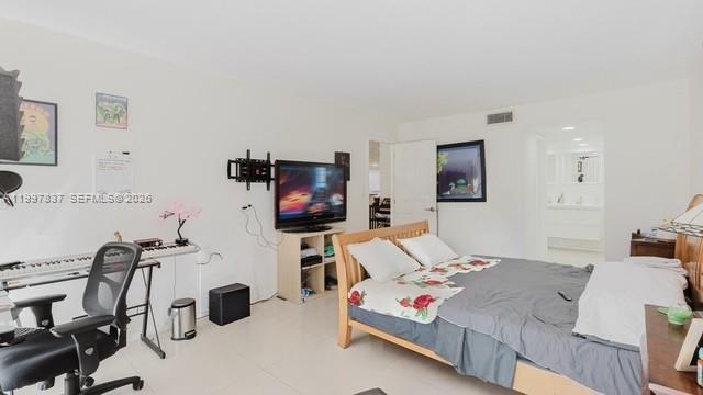 101 Southwest 96th Terrace, Unit 101 Plantation, FL 33324 - Photo 18 of 37 a bedroom with furniture a flat screen tv and a couch