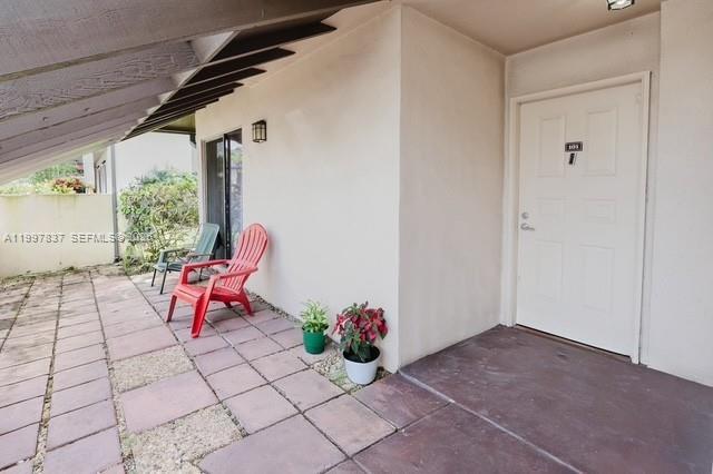 101 Southwest 96th Terrace, Unit 101 Plantation, FL 33324 - Photo 2 of 37 a outdoor space with lots of white furniture
