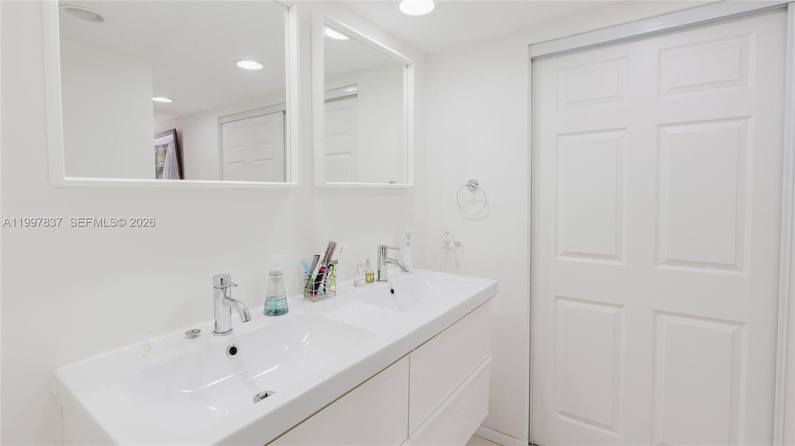 101 Southwest 96th Terrace, Unit 101 Plantation, FL 33324 - Photo 21 of 37 a bathroom with a sink and a mirror