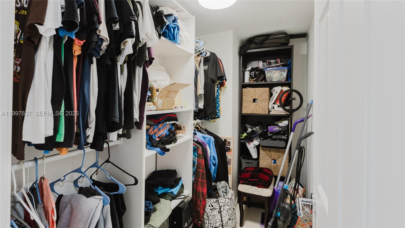 101 Southwest 96th Terrace, Unit 101 Plantation, FL 33324 - Photo 22 of 37 a view of walk in closet with clothes and shoes