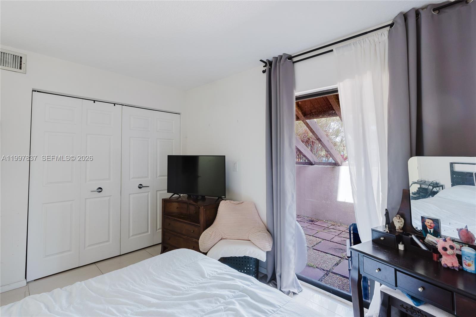 101 Southwest 96th Terrace, Unit 101 Plantation, FL 33324 - Photo 23 of 37 a bedroom with a bed and a television