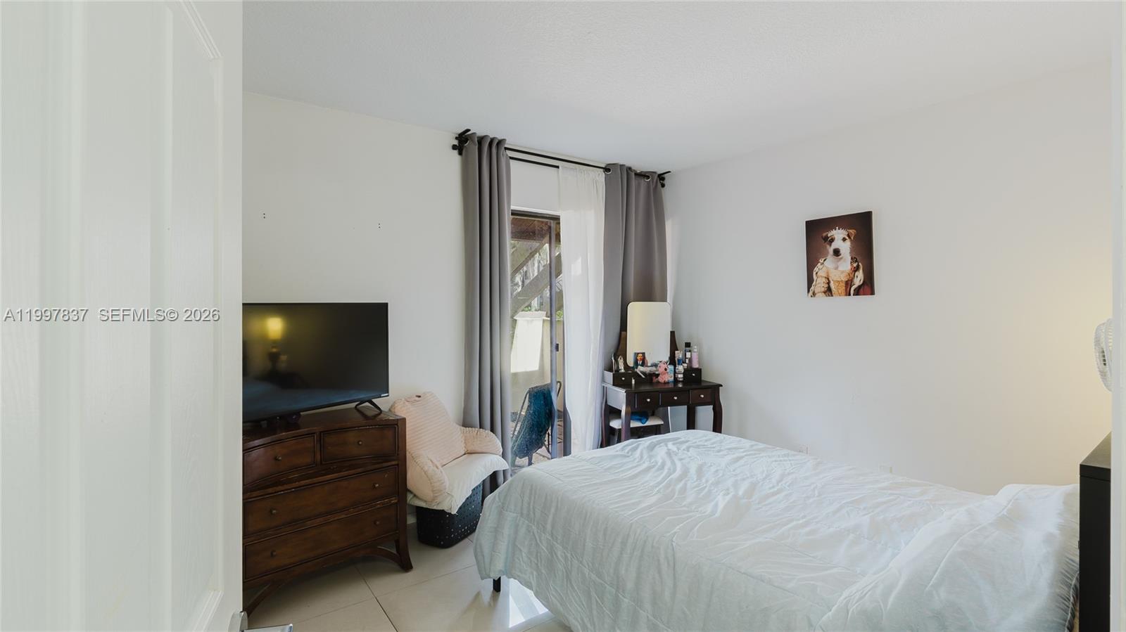 101 Southwest 96th Terrace, Unit 101 Plantation, FL 33324 - Photo 25 of 37 a bedroom with a bed and a flat screen tv