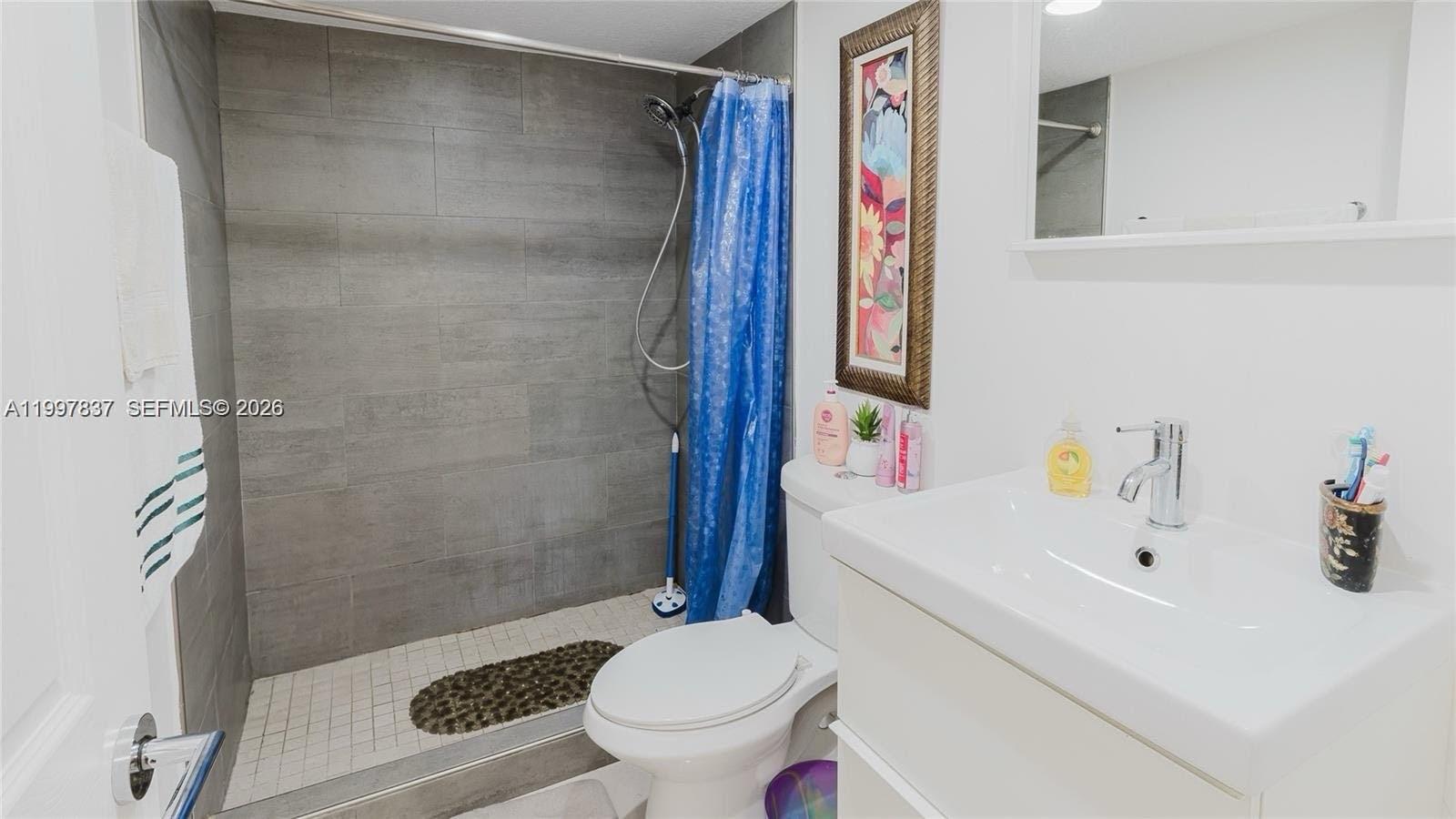 101 Southwest 96th Terrace, Unit 101 Plantation, FL 33324 - Photo 26 of 37 a bathroom with a sink toilet and shower