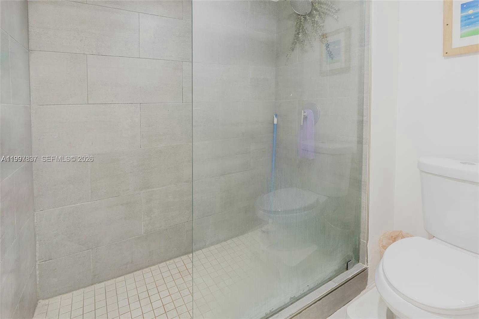 101 Southwest 96th Terrace, Unit 101 Plantation, FL 33324 - Photo 27 of 37 a bathroom with a shower and a toilet
