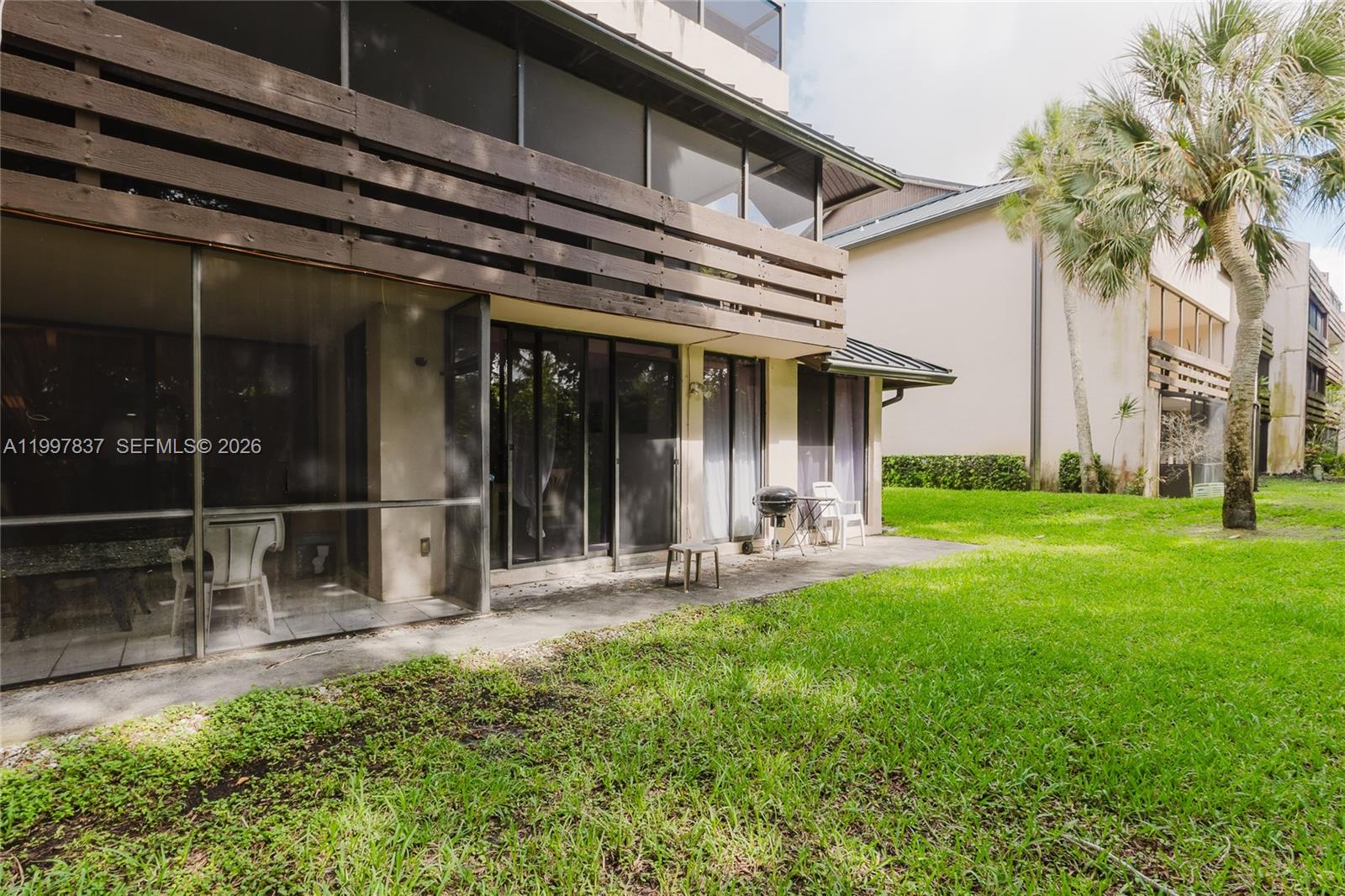 101 Southwest 96th Terrace, Unit 101 Plantation, FL 33324 - Photo 35 of 37 a view of a house with backyard porch and sitting area