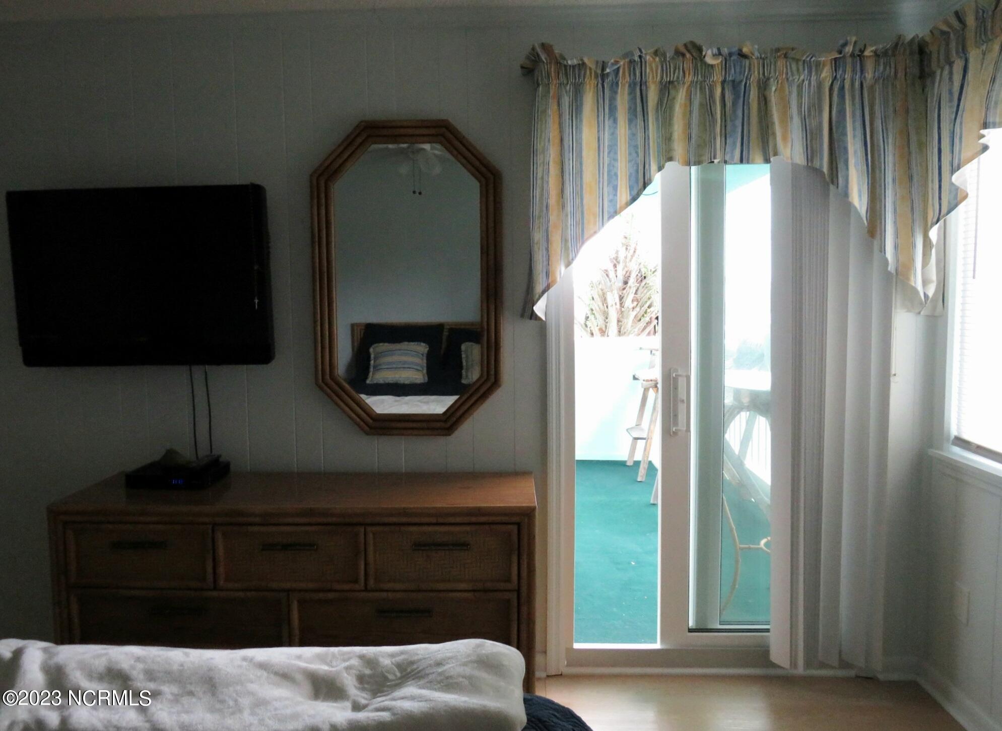 301 Commerce Way, Unit 104 Atlantic Beach, NC 28512 - Photo 14 of 33 Master bedroom balcony entrance